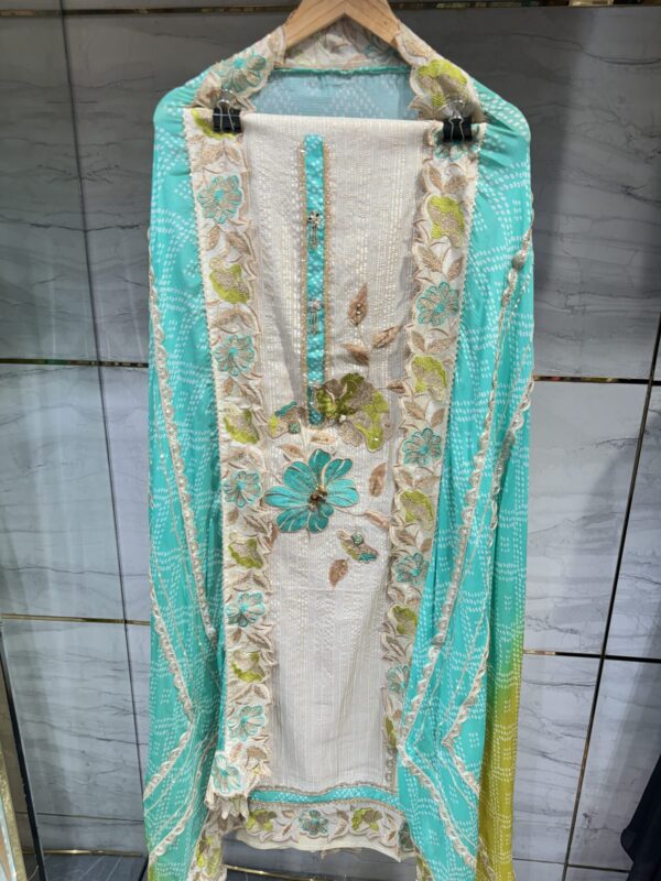 Pure tissue unstitched suit adorned with unique floral embroidery.